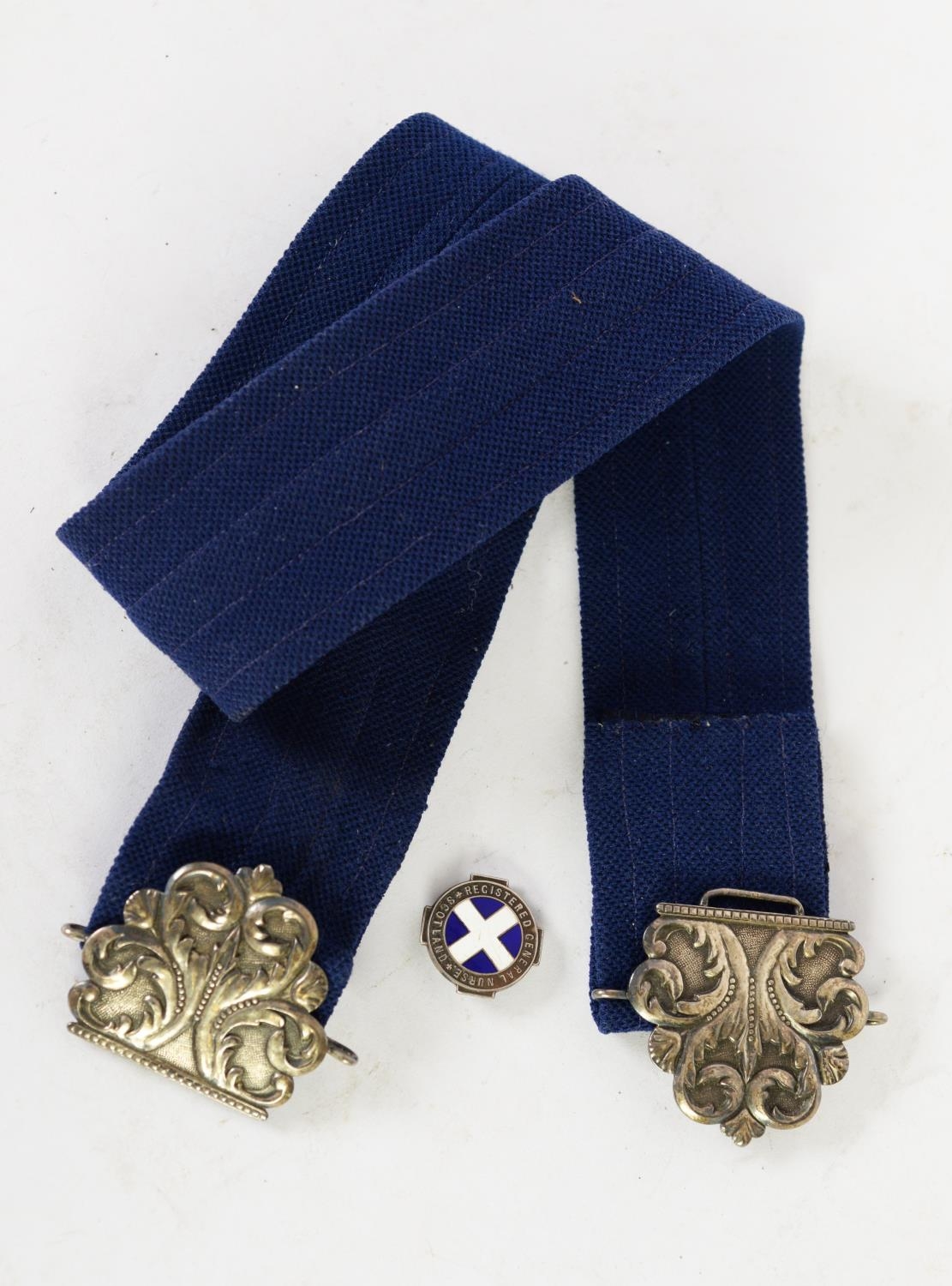 NURSES CAST SILVER TWO-PART BUCKLE, raised foliate scroll design on a matted ground, hallmark