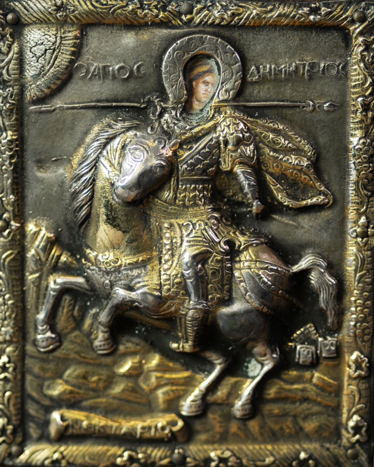TWENTIETH CENTURY BYZANTINE SILVER RELIEF AND PAINTED ICON of a saintly warrior on rearing horse,