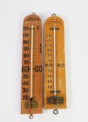TWO BLONDE WOOD FACTORY THERMOMETERS, one marked for the Factory Act, (2)