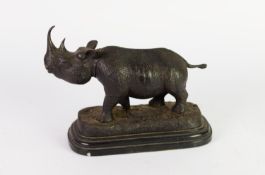 PATINATED BRONZE MODEL OF A RHINOCEROS, SIGNED JULIE MOIGNIEZ, on a moulded black veined marble