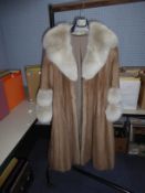 LIGHT BROWN FULL-LENGTH FUR COAT with deep shawl collar, slit pockets, interior silk tie fastening