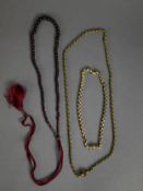 TWO SIMILAR GILT METAL BELCHER CHAIN NECKLACES with cylindrical clasps applied with flowers, one set