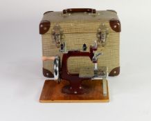 CIRCA 1950s MINIATURE HAND SEWING MACHINE with chromed metal fittings, marooon metal frame, almost