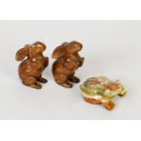 PAIR OF ALIKE CARVED MOTTLED BROWN SOAPSTONE MODELS OF RABBITS, raised on their hind legs, 3 1/