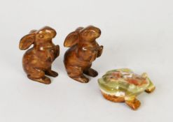 PAIR OF ALIKE CARVED MOTTLED BROWN SOAPSTONE MODELS OF RABBITS, raised on their hind legs, 3 1/