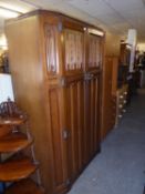 A LINEN FOLD CARVED OAK BEDROOM SUITE OF SIX PIECES, VIZ LADY’S AND GENT’S WARDROBES; A PEDESTAL