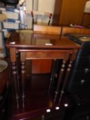 A NEST OF LINE INLAID MAHOGANY OBLONG COFFEE TABLES AND A BUTTONED BLACK LEATHER CLOTH SQUARE POUFFE