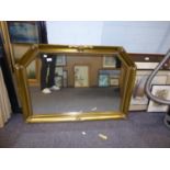 A LARGE GILT FRAMED RECTANGULAR WALL MIRROR