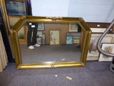 A LARGE GILT FRAMED RECTANGULAR WALL MIRROR