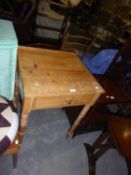 EARLY TWENTIETH CENTURY PINE SMALL SIDE TABLE WITH LEDGE BACK, FRIEZE DRAWER AND TURNED FRONT