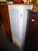 A BEECH AND WHITE FINISH TALL, NARROW FLOOR STANDING BATHROOM CABINET, WITH CURTAIN PANEL TO THE