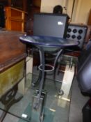 A LARGE RIBBED AND SHADED BLUE GLASS SHALLOW BOWL, ON BLACK WROUGHT IRON TRIPOD FLOOR STANDING