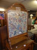 A CARVED AND FIGURED WALNUT CHEVAL GRATE SCREEN, WITH GLAZED AND FLORAL NEEDLEWORK TAPESTRY