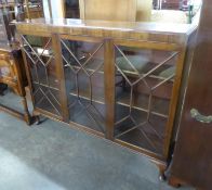 A MAHOGANY DWARF BOOKCASE ENCLOSED BY THREE ASTRAGAL GLAZED DOORS, 4’6” WIDE