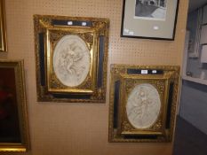 PAIR OF TWENTIETH CENTURY MOULDED COMPOSITION OVAL PLAQUES, DEPICTING CLASSICAL MAIDENS AND CHERUBS,