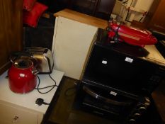 PANASONIC BLACK CASED MICROWAVE OVEN; TEMPO RED FINISH ELECTRIC KETTLE; AN ELECTRIC TOASTER AND A ‘