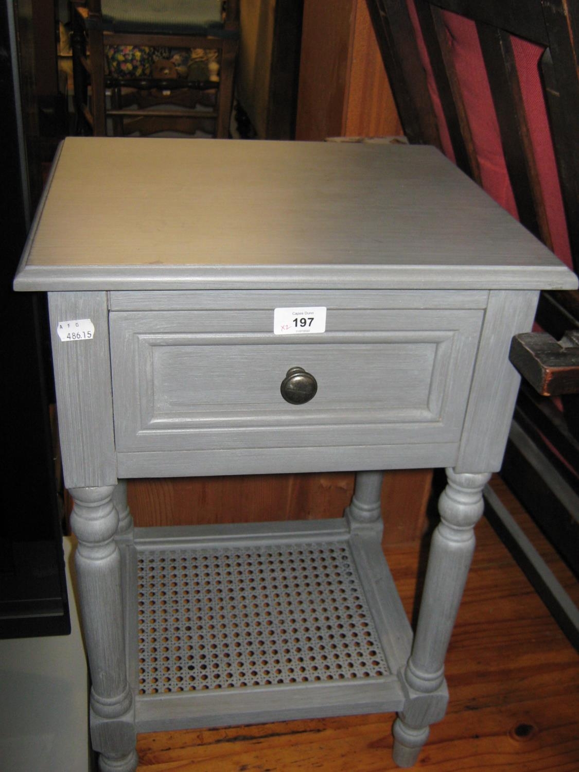 A GREY PAINTED WOOD BEDSIDE PEDESTAL WITH DRAWER AND CANE PANEL UNDERSHELF AND A BLOND WOOD SINGLE