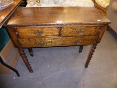 AN OAK OBLONG SIDE TABLE WITH A SLIDE OVER TWO SHORT AND ONE LONG DRAWER, ON SPIRALLY TWISTED