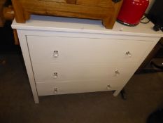 A WHITE FINISH CHEST OF THREE LONG DRAWERS WITH FACETED GLASS KNOB HANDLES, 2’11” WIDE