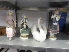 FOUR LLADRO FIGURES, A SEATED GIRL READING; A SEATED GIRL WITH VASE OF FLOWERS , A GIRL CARRYING A