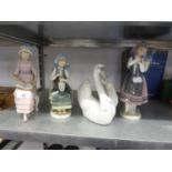 FOUR LLADRO FIGURES, A SEATED GIRL READING; A SEATED GIRL WITH VASE OF FLOWERS , A GIRL CARRYING A