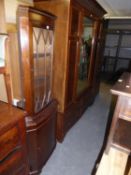 A MAHOGANY GEORGIAN STYLE BOW FRONTED DOUBLE CORNER CUPBOARD