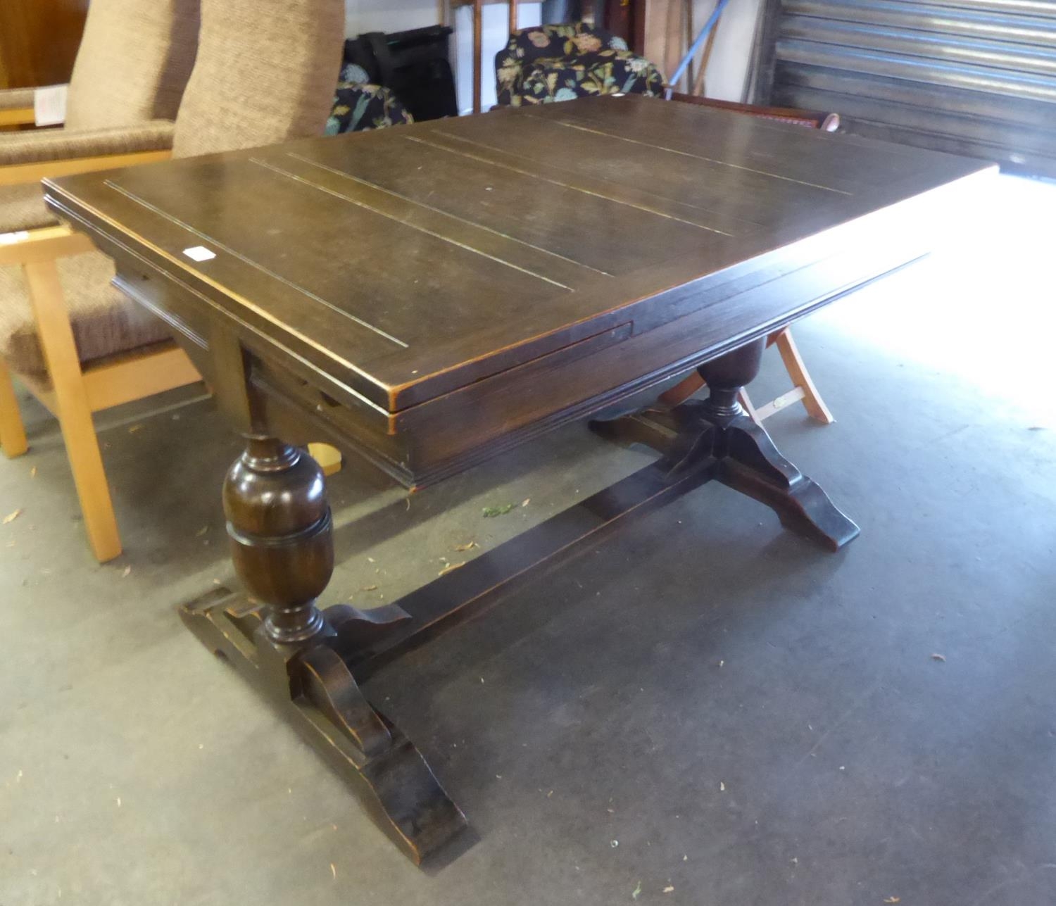 AN OAK DRAW LEAF DINING TABLE