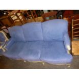 A CREAM FINISH FLORAL COVERED BEECHWOOD, SIX CUSHION, THREE SEATER SETTEE, IN BLUE PLUSH