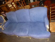 A CREAM FINISH FLORAL COVERED BEECHWOOD, SIX CUSHION, THREE SEATER SETTEE, IN BLUE PLUSH