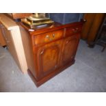A MAHOGANY SMALL SIDEBOARD WITH TWO DRAWERS OVER TWO DOORS, ON PLINTH BASE, 2’7”