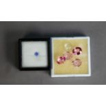 White plastic vision box containing FOUR UNMOUNTED PINK GEM STONES and ONE WHITE OVAL GEM STONE
