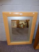 A WALL MIRROR IN MODERN LIGHT WOOD FRAME