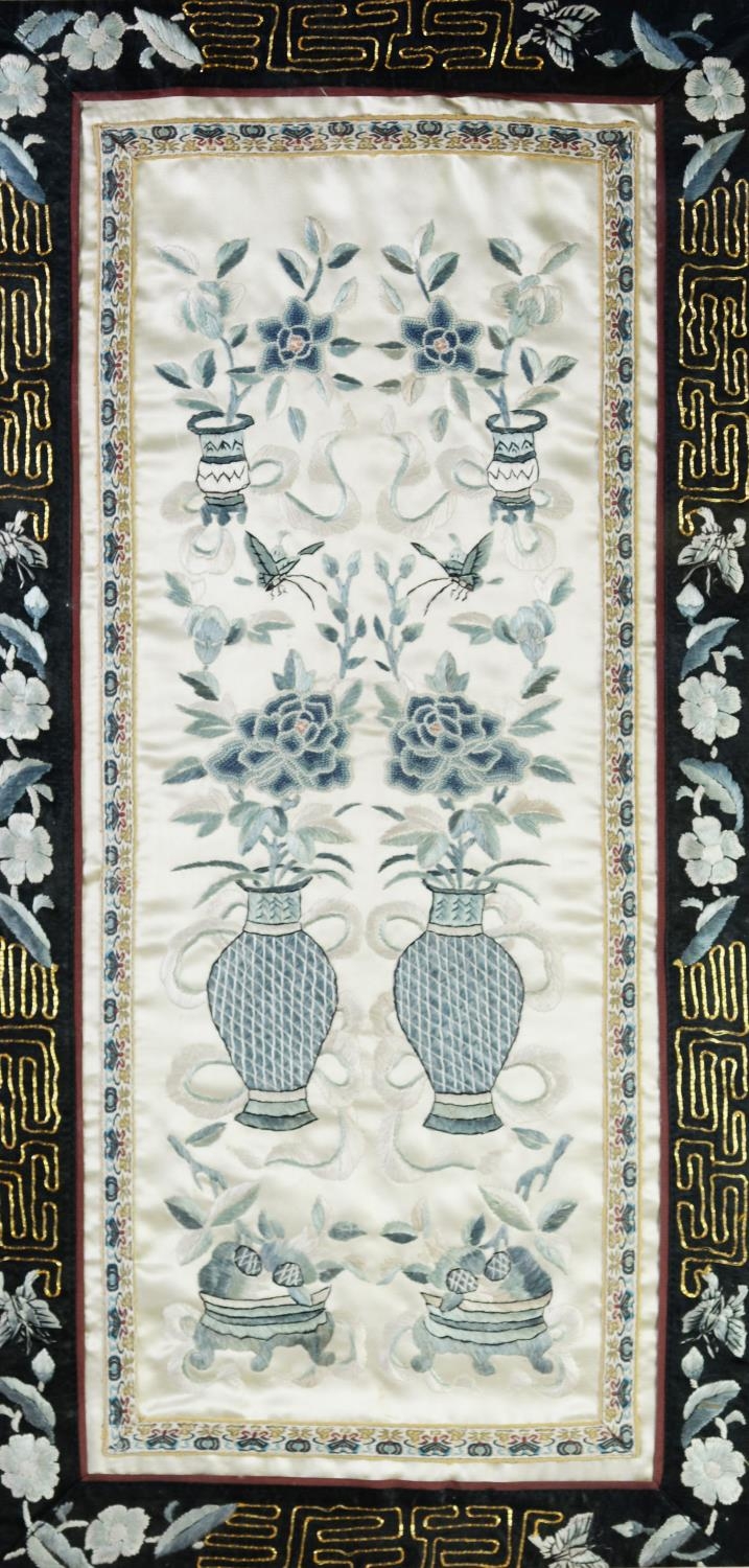 CHINESE EMBROIDERED SILK PANEL, decorated with six urns of flowers in blue and white on a grey