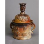 CIRCA 1840 LAMBETH STYLE BROWN GLAZED STONEWARE TWO HANDLED TOBACCO JAR, with cover as a candle