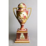 POST 1862 VIENNA PORCELAIN TWO HANDLED PEDESTAL VASE WITH DOMED COVER, the richly gilded claret