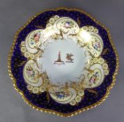 CHAMBERLAINS WORCESTER PORCELAIN ARMORIAL SOUP DISH, the centre with two crests within a lavish