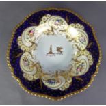 CHAMBERLAINS WORCESTER PORCELAIN ARMORIAL SOUP DISH, the centre with two crests within a lavish