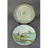 BELGIAN TUBE LINED CIRCULAR POTTERY WALL PLAQUE depicting a river landscape and windmill in pastel