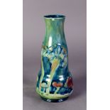 WILLIAM MOORCROFT FOR LIBERTY & Co, CLAREMONT PATTERN TUBE LINED POTTERY VASE, of slender double
