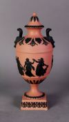 WEDGWOOD BLACK ON TERRA COTTA JASPER WARE TWO HANDLE PEDESTAL VASE AND SMALL BELL SHAPED COVER,
