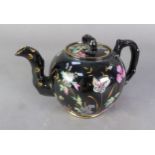 A VICTORIAN STAFFORDSHIRE POTTERY BLACK GLAZED SMALL TEAPOT, enamelled and gilt with flowering