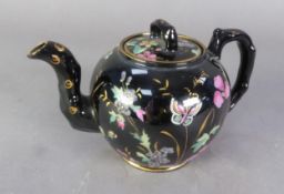 A VICTORIAN STAFFORDSHIRE POTTERY BLACK GLAZED SMALL TEAPOT, enamelled and gilt with flowering