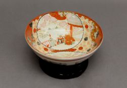 JAPANESE KUTANI PORCELAIN BOWL, painted with figures by a balcony and a river landscape, in