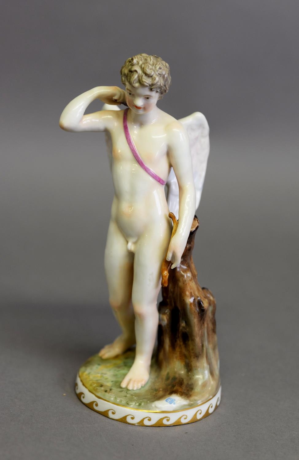 19th CENTURY GERMAN NYMPHENBURG PORCELAIN FIGURE OF A WINGED CUPID holding a bow (incomplete),