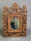 LATE 19th CENTURY CHINESE CANTON INTRICATELY CARVED SANDALWOOD MIRROR, the oval plate within a