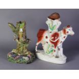 VICTORIAN STAFFORDSHIRE POTTERY STANDING COW SPILL HOLDER GROUP, the cow with iron red detail and