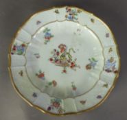 18th CENTURY MEISSEN PORCELAIN SCALLOPED PLATE with ozier moulded border, polychrome enamelled in