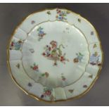 18th CENTURY MEISSEN PORCELAIN SCALLOPED PLATE with ozier moulded border, polychrome enamelled in