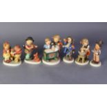 SIX VARIOUS GOEBEL HUMMEL FIGURES AND GROUPS to include boy and girl standing beside a child in a