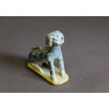LATE 18th/EARLY 19th CENTURY, POSSIBLY STAFFORDSHIRE EARTHENWARE PRIMATIVE MODEL OF A DOG, seated